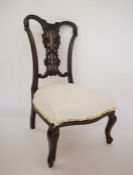 Low Victorian bedroom chair in Chippendale style, with carved back, on cabriole front legs