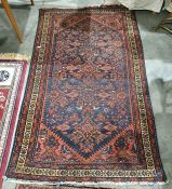 Persian rug, blue ground field with red ground decoration, stepped border, 192cm x 113cm