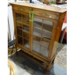 20th century oak display cabinet with astragal-glazed doors enclosing shelves, on barleytwist