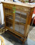 20th century oak display cabinet with astragal-glazed doors enclosing shelves, on barleytwist