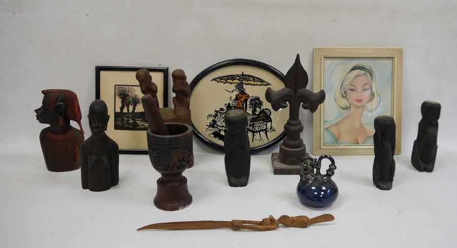 Collection of African carved wooden figures and heads, a cast iron fleur-de-lis, a cut paper