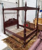 Modern mahogany four-poster bed with turned and carved posts and heavily carved headboard (with