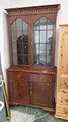 20th century bookcase cabinet with moulded cornice above two astragal-glazed doors, on rectangular