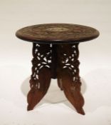 Eastern carved coffee table with bone inlay and folding carved base, 38cm diameter