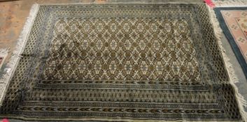 Eastern cream ground rug with stepped lozenge, floral border flanked by multiple geometric guard