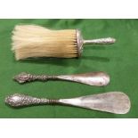 Two silver-mounted shoehorns and a brush (3)