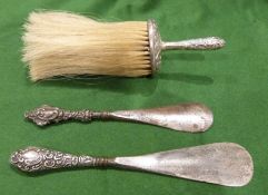 Two silver-mounted shoehorns and a brush (3)