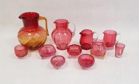 Collection of late Victorian and Edwardian cranberry glass including four jugs in sizes, one with