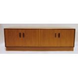 Low G-Plan teak sideboard with four cupboard doors, on plinth base, 162cm x 54cm