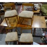 McIntosh mid-century modern teak dining table and four chairs with upholstered seats, on cylindrical