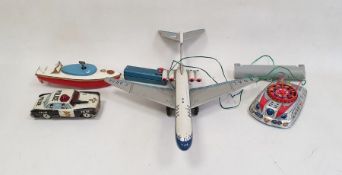 Collection of vintage toys including BOAC plane, battery operated police car and vintage hand