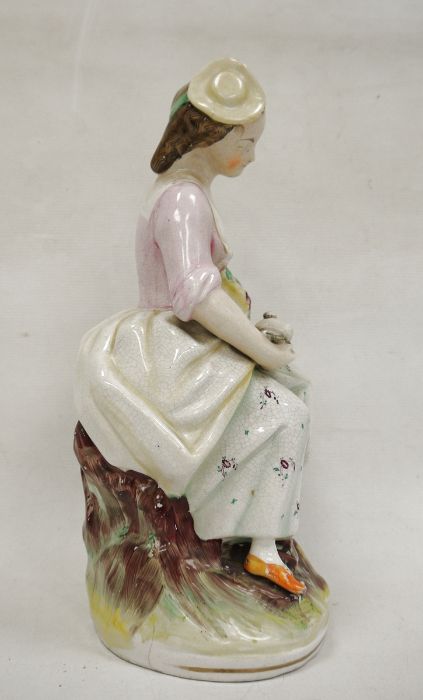 Staffordshire pottery figure of a lady vintner, late 19th century, she modelled seated holding a - Bild 4 aus 5