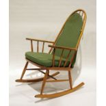 Modern beech stickback rocking chair with green upholstered seat and back cushion