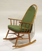 Modern beech stickback rocking chair with green upholstered seat and back cushion