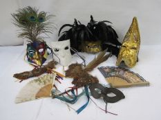 Assortment of Venetian and Venetian style masks with peacock, pheasant and costume feathers. (8)