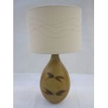 20th century table lamp with studio pottery body in browns, with a cream-coloured shade