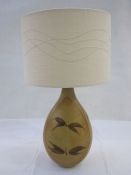 20th century table lamp with studio pottery body in browns, with a cream-coloured shade