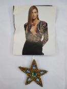 Yves Saint Laurent  paste star brooch with necklace loop, with a fashion page photo of the brooch