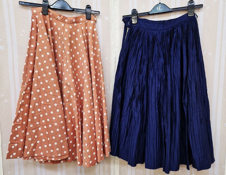 1950's skirts to include caramel- coloured full circle skirt with white spots, a blue pleated skirt,