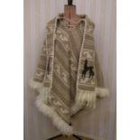 An Alpaca woollen poncho with tie front, matching scarf, fur trim and an appliqued alpaca onto the