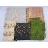 Assorted textiles to include black raw silk fabric embroidered in gold-coloured thread, floral