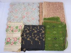 Assorted textiles to include black raw silk fabric embroidered in gold-coloured thread, floral