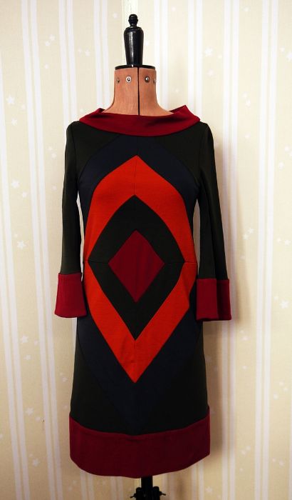 Diane Von Furstenberg wool dress, geometric pattern in orange and maroon on a dark green background,