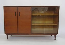 Meredew teak bookcase with two cupboard doors and glass doors encasing shelves, turned supports (