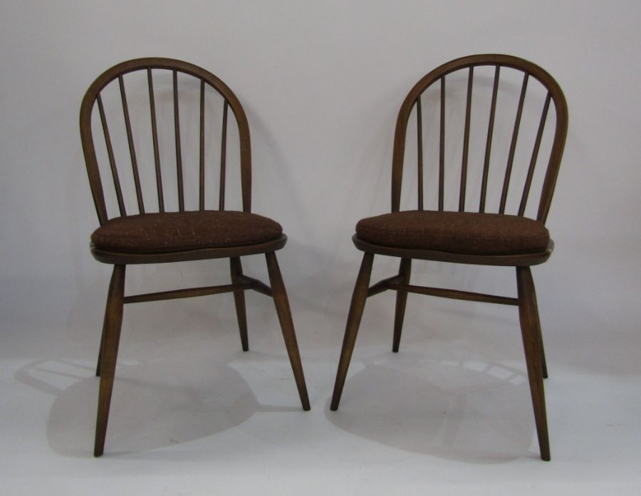 A pair of elm Ercol stickback dining chairs