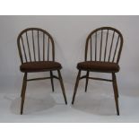 A pair of elm Ercol stickback dining chairs