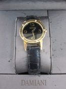 Damiani 18ct gold watch with 5 diamonds outside rim with black face in original box, the face