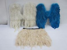 Two pairs of feathered angel wings, one turquoise coloured and one white  ( the white one has