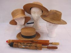 Two paper laquered parasols and a selection of  vintage and later woven hats to include Asian-style,