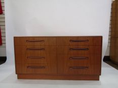 G-Plan teak chest of eight drawers in two rows on plinth base and scroll handles  (140cm wide x 73cm