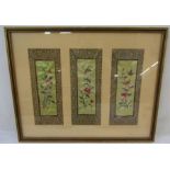 Three Chinese embroidered panels framed as one, depicting birds, flowers, insects within a border,