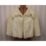 White mink short jacket with bracelet sleeves and a costume diamante broochCondition ReportAppears