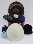 Assorted vintage hats and wedding fascinators of various colours, including feather head decoration,