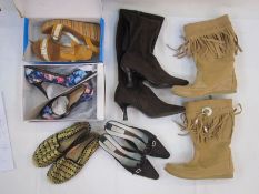 Assorted vintage and modern shoes including tall suede boots, suede heels, tartan flats and