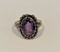Silver-coloured metal ring set oval alexandrite-coloured stone
