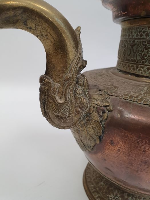 Late 19th century or later, Tibetan copper and brass fitted teapot, with Naga form handle. - Image 17 of 33