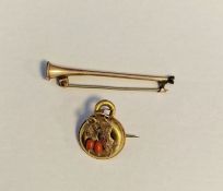 Gold-coloured metal small circular brooch with coral bead and gold-coloured metal coaching horn