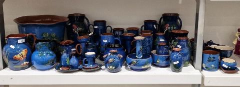 Large quantity of Watcombe Torquay and similar blue and brown pottery decorated with birds, to