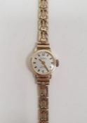 Lady’s Polaris 9ct gold wristwatch with circular champagne face, on triple-gate bar bracelet, 11.