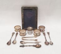 Five assorted silver napkin rings and sugar tongs, foreign white metal teaspoons, silver picture