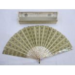 A late 19th Century fan embroidered with silver and gold sequins, mounted on cream mother-of-pearl