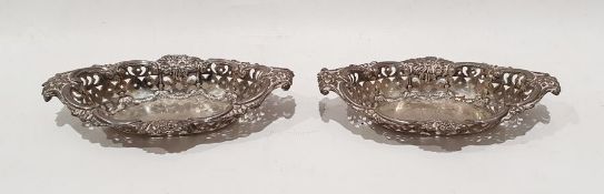 Pair of Edward VII silver trinket dishes, oval shaped with pierced sides and flower decorated. (