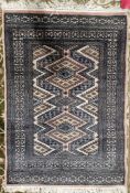 Modern cream ground rug with geometric pattern flanked by multiple geometric guard stripes 124cm X