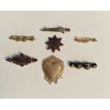 Gold-coloured metal and garnet star-shaped brooch, another shaped rectangular, antique gold pique