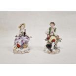 Pair continental porcelain figures of lady seated with flowers and basket of flowers at her feet,