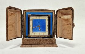 Early 20th century travel clock in original case, the 8 cm square dial with blue enamel, gilt Arabic